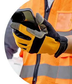 Image of someone in a hi-vis jacket using a phone